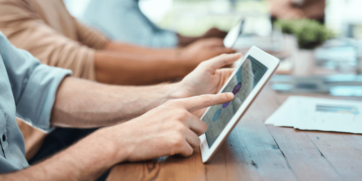 A man interacting with social media post on a white tablet