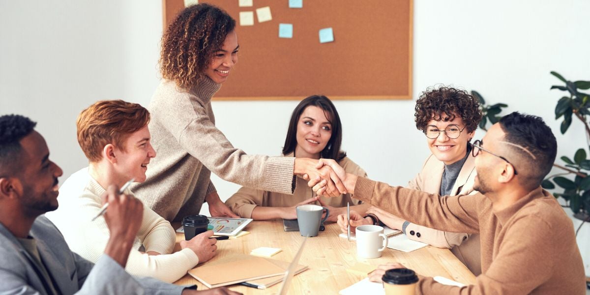 A photo of agency manager shaking hands with a happy client