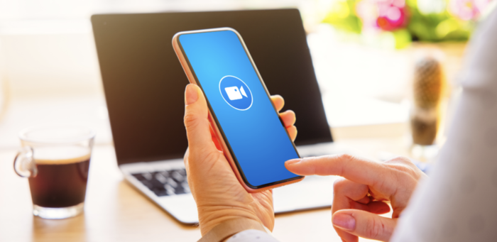 tiktok video editors woman on laptop with phone
